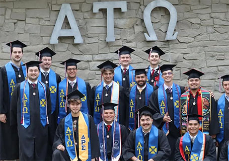 Graduating members ofAlpha Tau Omega pose outside of their fraternity house